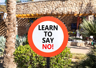 Learn to say no symbol. Concept words phrase Learn to say no on beautiful road sign. Beautiful palm...