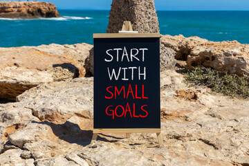Start with small goals symbol. Concept words phrase Start with small goals on beautiful black...