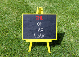 End of tax year symbol. Concept words phrase End of tax year on beautiful black blackboard....