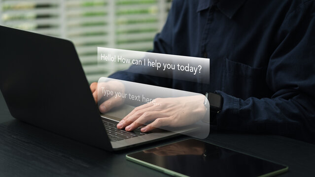 Close-up of a person interacting with an AI chatbot on a laptop, illustrating the integration of artificial intelligence in modern work and everyday digital communication.