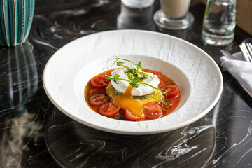Portion of gourmet italian breakfast with mozzarella tomatoes and poached egg