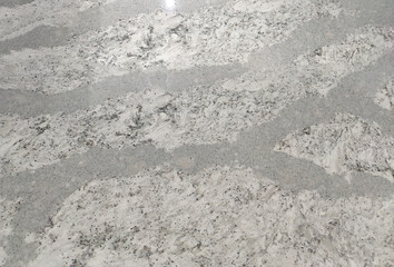 Close-Up of Light Grey and White Granite Surface with Unique Pattern and Texture Detail