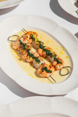 Portion of gourmet grilled shrimp skewers with sauce