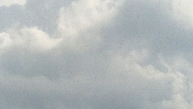Cloudy skies paint the atmosphere with softness and subtle drama, diffusing light and muting the landscape below