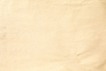 Crumpled texture of a pale beige paper sheet