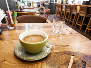 Green Coffee Cup on Wooden Cafe Table