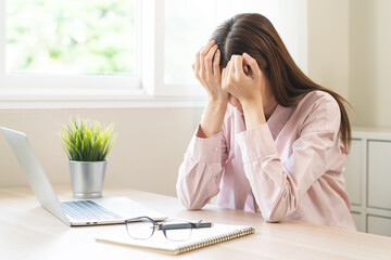 Stressed, exhausted asian young woman having migraine symptoms headache, bored sitting work long...