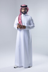 A collection of images of an Arab man wearing traditional Saudi thobe and shemagh, reflecting modern lifestyle activities like using technology, shopping, and standing confidently in a studio setting.