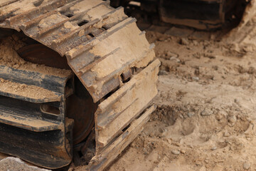Close-up of excavator track. Close-up of part of construction excavator, tracked vehicle. Repair work in the city. Special equipment. Equipment at the construction site. Heavy construction equipment