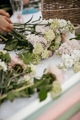 table with flowers and supplies for making bouquets