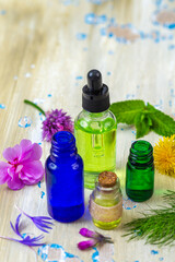 Essential oils and herbs on table