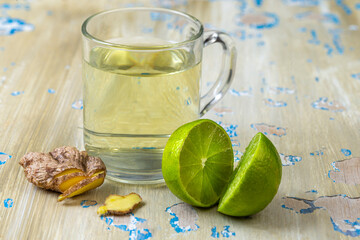 Ginger and lime drink on a rustic wooden table
