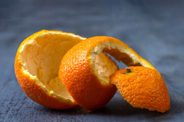 Freshly peeled orange on a textured background