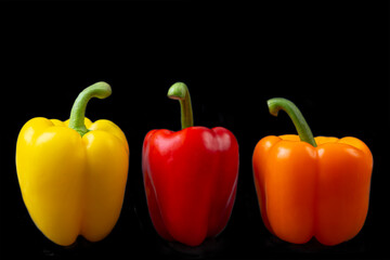 Colorful peppers on black background