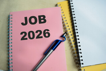 Concept of Job 2026 write on book isolated on Wooden Table.