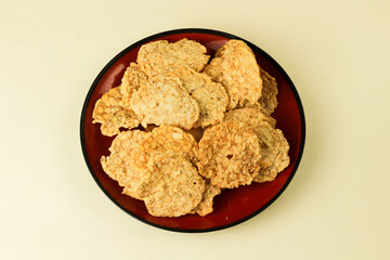 Tempeh chips served on a plate and isolated on a white background.