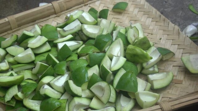 Raw mango is a tangy, green fruit with firm flesh, often used in pickles, chutneys, and refreshing summer drinks.