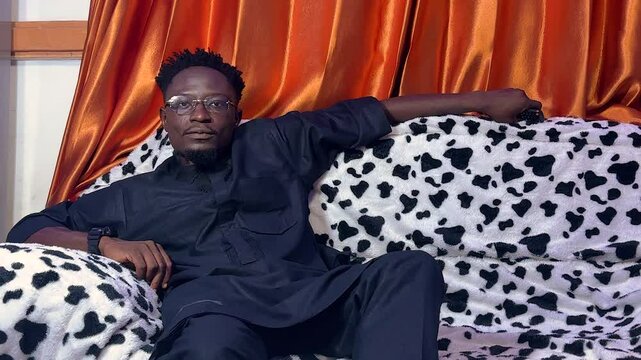 man sitting comfortably looking ardor of watching TV programs 