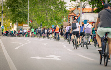 Group of cyclists on city road, street, asphalt