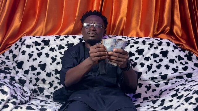 obsolete payment method of a young black man worried on how to continue tv programs with cash payment