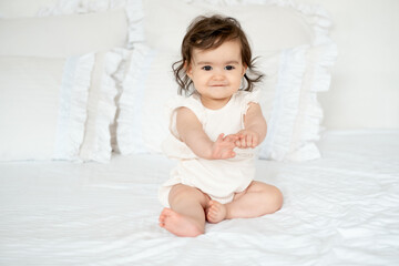 Baby girl, smiling newborn little baby on the bed at home
