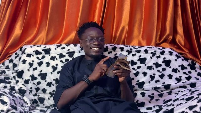 Black, handsome Young man happy cashing out. Calculation Spend Cash Concepts