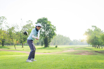 Asian amateur golfer is performing a tee off swing, man playing golf in golf course.