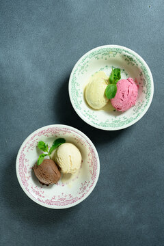 two scoops of ice cream in a bowl 