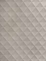 Close up of white diamond geometrical 3D pattern carved on a board. Suitable for wall panel or other design element. 3D panel graphic background. Seamless background texture