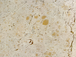 Close up of beige marble with random brown dots and dark veins. Bright color minerals marble suitable for wall and flooring. Seamless background texture.