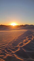 Rolling sand dunes glowing under the setting sun, glowing sand dunes at sunset. Vertical