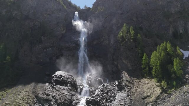 Waterfall in the mountains. Majestic view of Engstligen Falls in Switzerland. Powerful alpine waterfall plunging over rocks in a dramatic natural setting, captured in all its raw beauty.