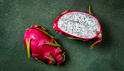 Dragon fruit, pitahaya, one piece, cut, top view, rustic style, green background,