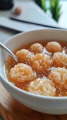 A bowl of sticky rice balls in sweet soup offers a comforting New Year treat. Vertical.