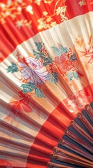 A close-up reveals a traditional Chinese fan adorned with intricate festive motifs. Vertical.