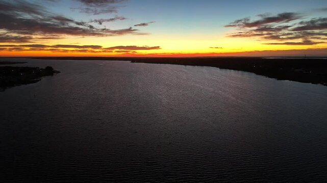 4k drone view of rays of the River Murray Sunset over Goolwa at sunset in South Australia