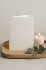 Serene Invitation Card with Candle and Eucalyptus on Wooden Tray
