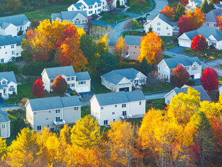 Aerial view of suburban housing community in autumn season with colorful trees
