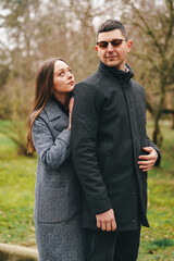 Fototapeta premium Couple enjoying a quiet moment in a park during a chilly afternoon