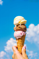 Ice Cream Cone with Melting Scoops against Bright Blue Sky — Summer Treat Concept aspect ratio 2:3