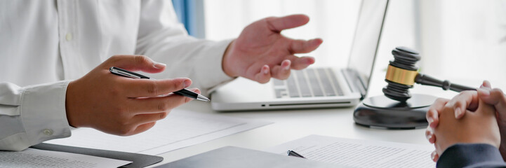 professional lawyer consulting with client about legal contract inside law firm meeting room