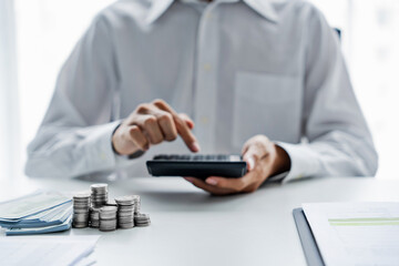 Close up of hand using calculator calculating personal finance for income and expenses