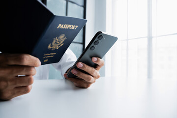 Hand holding passport and mobile phone for online flight booking and ticket purchase