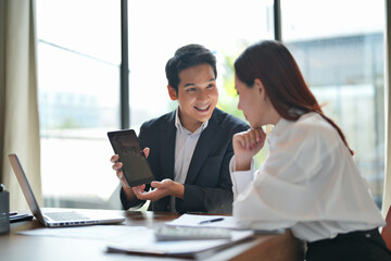 Corporate employee in Asia supervising mentor session for trainee in office with teamwork and career focus