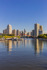 Fototapeta premium Hai River with cruise boat harbor and apartment buildings in Tianjin, China