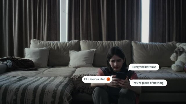 Medium full shot of anguished young Caucasian girl crouching up on floor at home, scrolling social media, with VFX effects of vicious messages from online trolls appearing around her