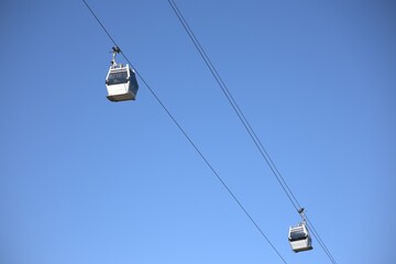 Obraz premium Two cable car cabs against the blue sky