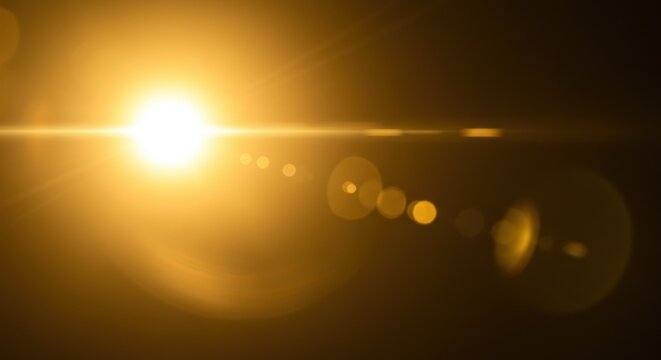 Bright golden sun with lens flare effect against dark background. Warm light source with bokeh circles. Cinematic optical phenomenon. Photography lighting technique