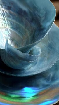 Macro shot of a iridescent paua shell interior with blue and green shimmer, abstract marine seashell close-up view