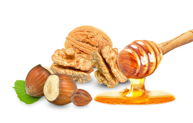 dripping honey and hazelnuts and walnuts isolated on white background